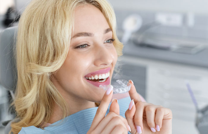 Image of a young woman wearing Invisalign, at Aspen Orthodontics clinic in Gilbert, Arizona